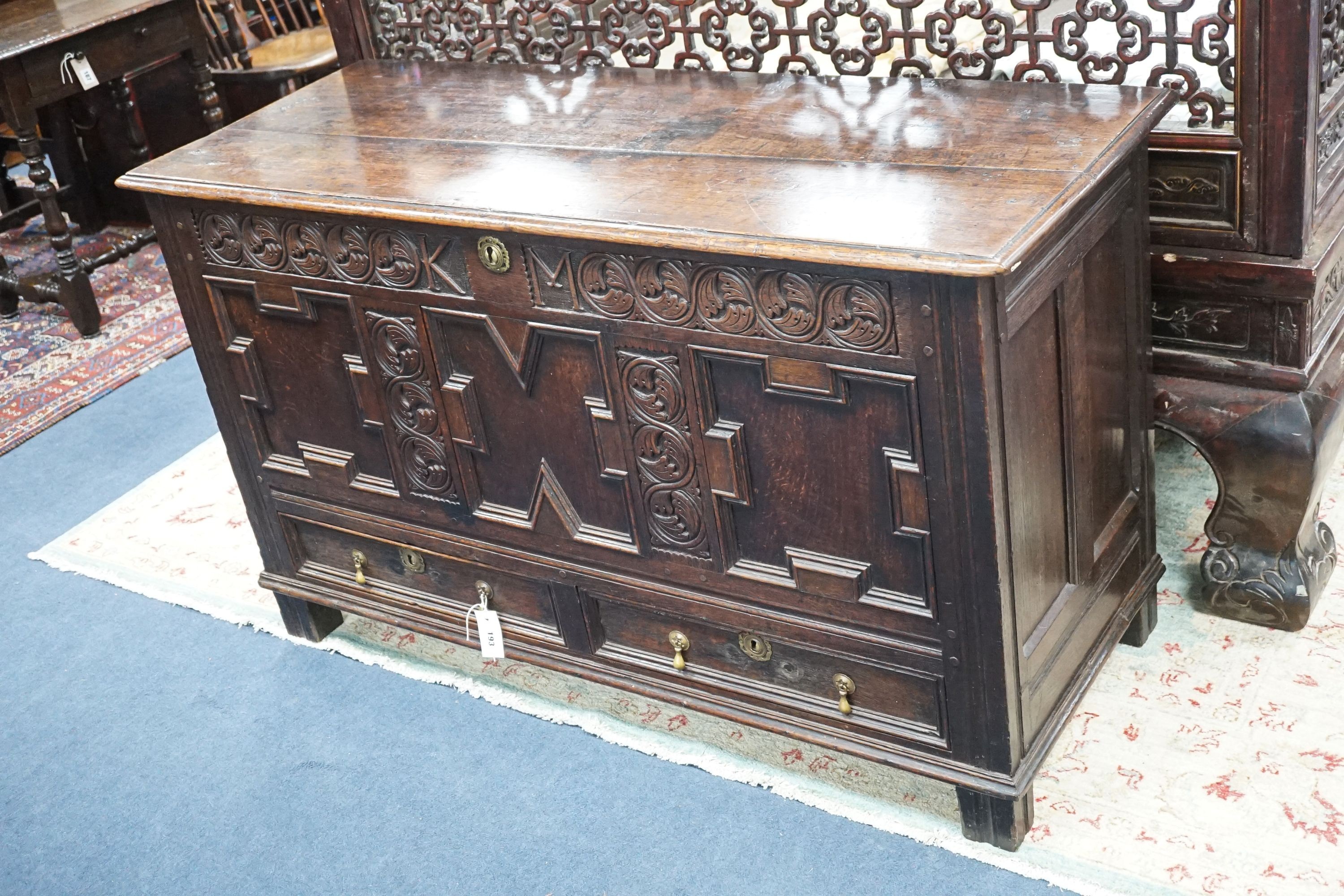 A William and Mary carved oak mule chest with K M initialled frieze and triple panelled front, length 132cm, depth 51cm, height 78cm